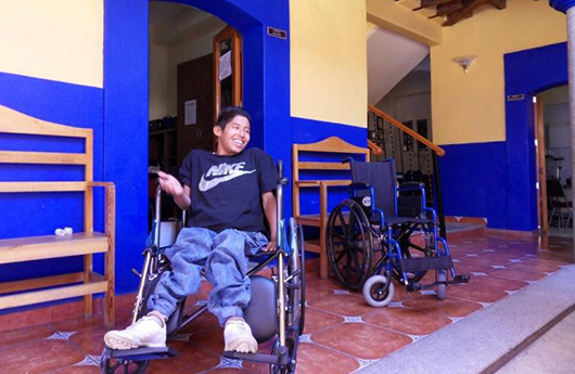 Smiling young man in wheel chair
