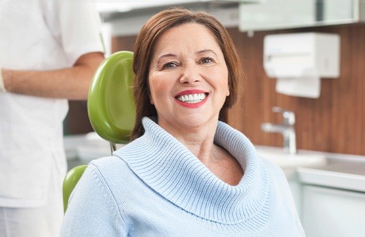 Woman with denture smile in dental chair