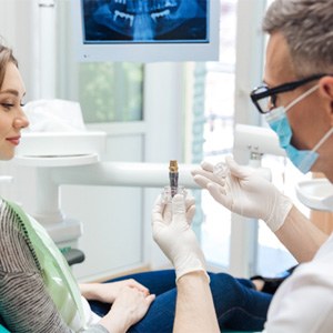 a dentist explaining how dental implants work in Lebanon