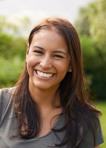 A smiling woman standing outdoors