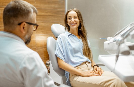 A young woman consulting her dentist about dental bonding