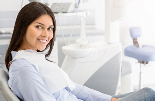 A smiling woman sitting in a dentist’s chair