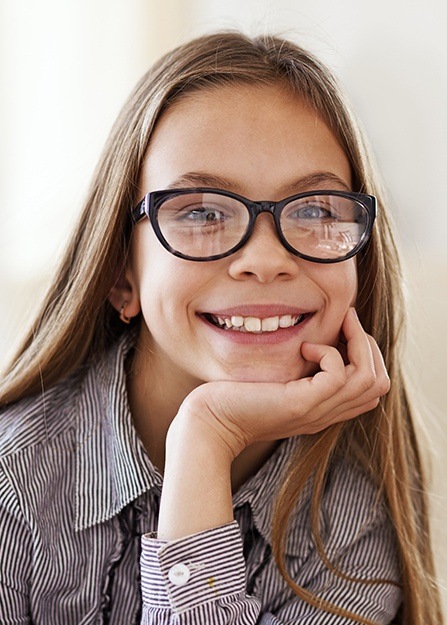 Young girl with healthy smile after children's dentistry