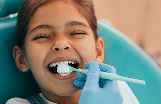 Child receiving dental checkup