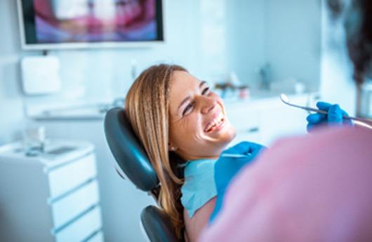 Patient smiling at dentist during dental checkup