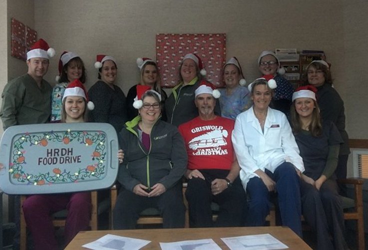 Team members posing for picture at food drive event