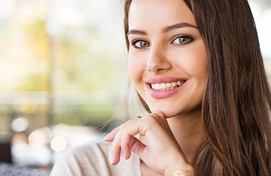 woman smiling after getting dentures