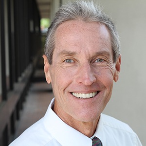 Man smiling at an office building