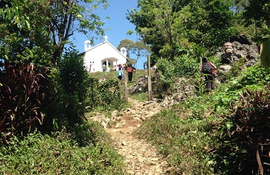 Building at the end of an uphill dirt path