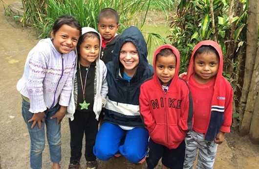 Dental team member and group of kids smiling together