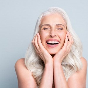 aAn older woman enjoying her new dental implants