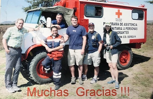 Volunteers next to mobile medical treatment truck