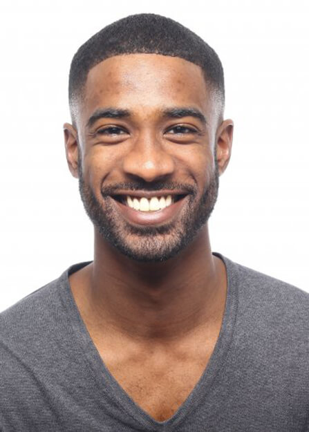 man in black shirt smiling with veneers in Lebanon against white background 