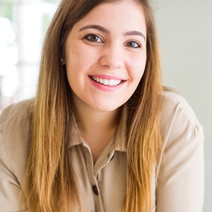 Closeup of woman with straight, white, healthy teeth smiling