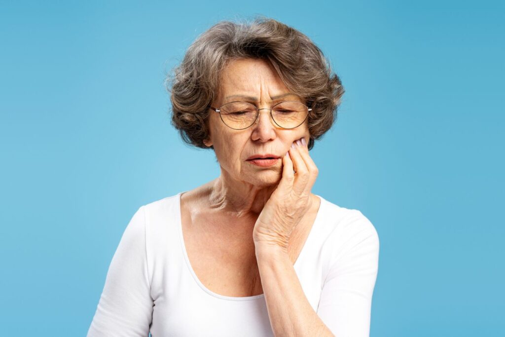 a woman with painful denture sores